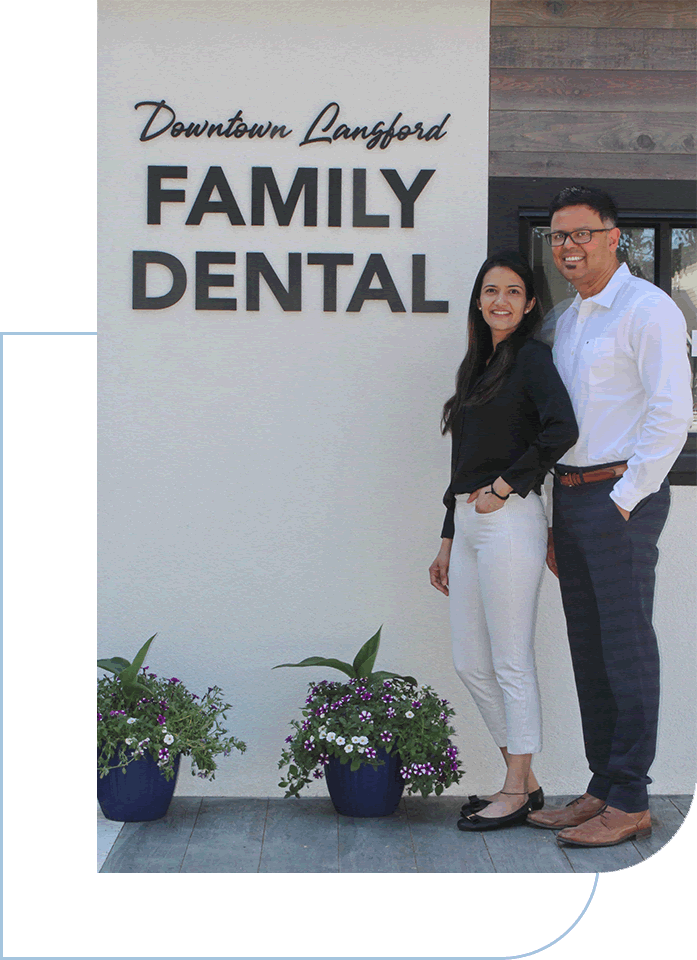 a man and woman standing in front of a sign